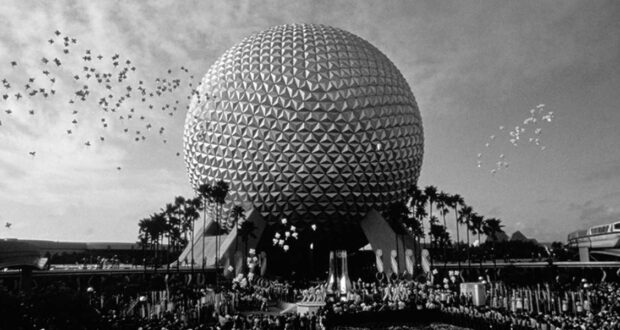 A black-and-white photo of EPCOT’s geodesic dome, Spaceship Earth, with crowds gathered below and balloons in the sky, surrounded by palm trees—capturing classic park sights near World Showcase’s Impressions de France.