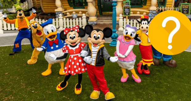 Beloved Disney characters gather for a group photo at Disneyland, with one character on the right—likely Pete—playfully hidden by a bold yellow question mark, adding an element of surprise to the magical scene.