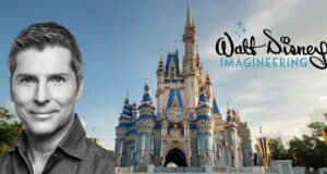 Bruce Vaughn of Walt Disney Imagineering posing with Cinderella Castle and the Imagineering logo in the background on a bright Disney day.