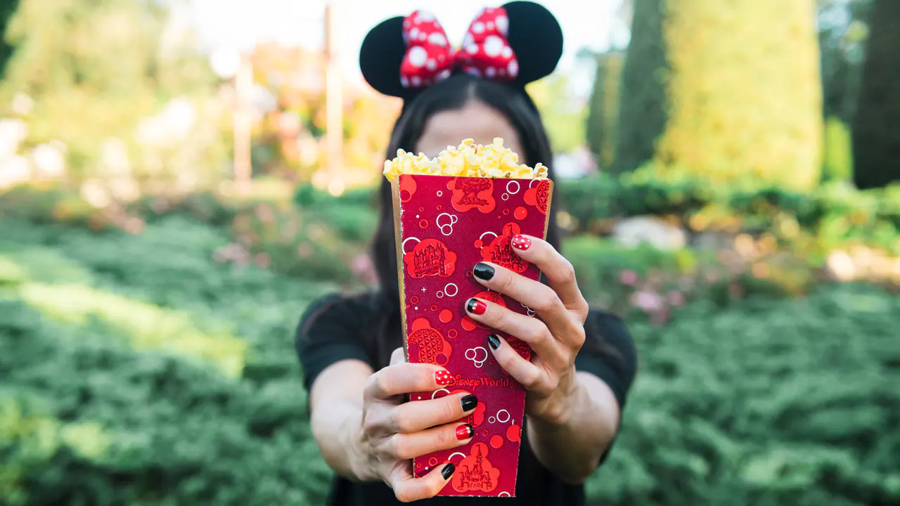 Girl holding box of popcorn
