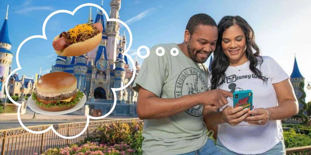 At Disney World, a couple checks their phone, debating between ordering a cheesy cheeseburger or a hot dog with cheese using Mobile Order as they plan their next delicious treat.