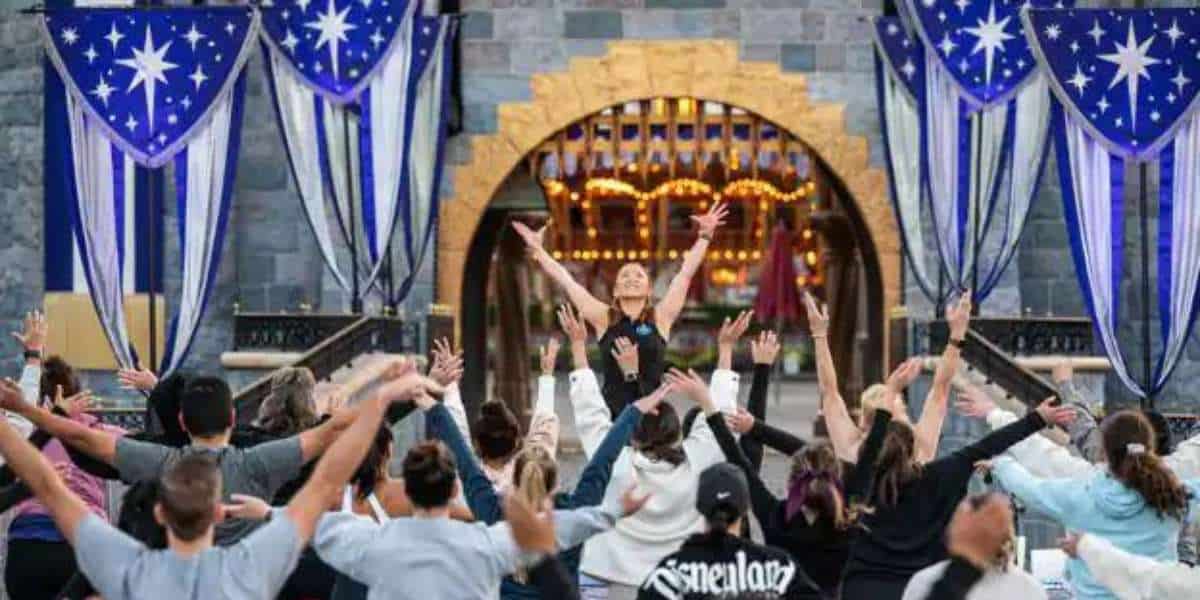 Cast Members Do Yoga in front of Sleeping Beauty Castle at Disneyland