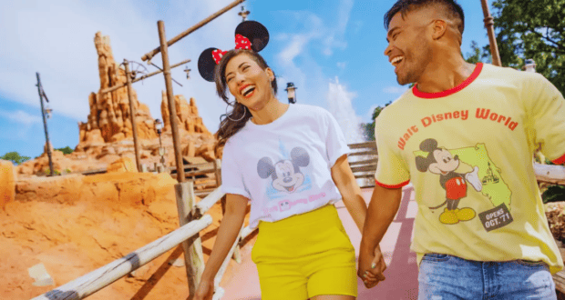 two guests wearing disney merchandise outside thunder mountain