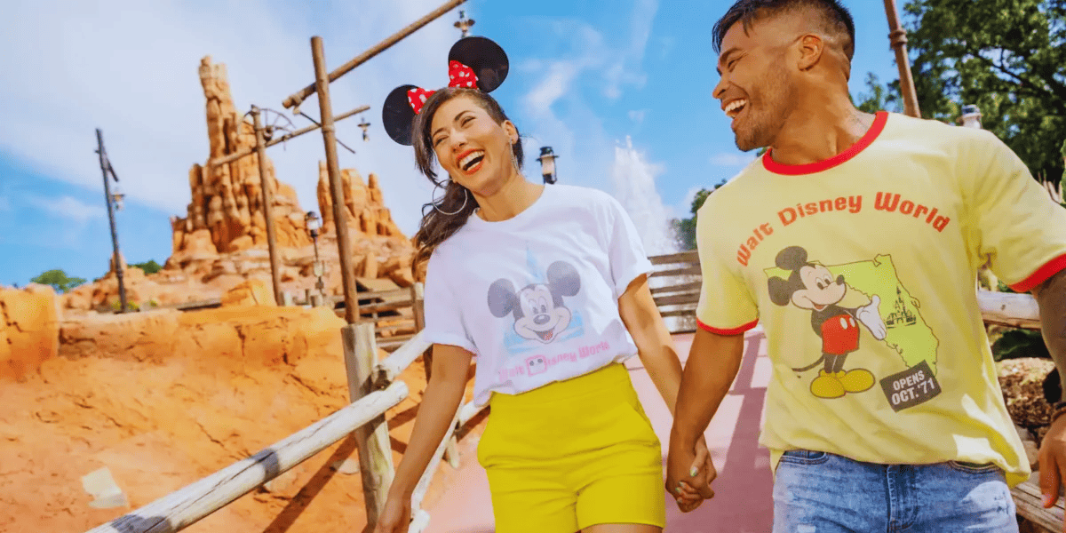 two guests wearing disney merchandise outside thunder mountain