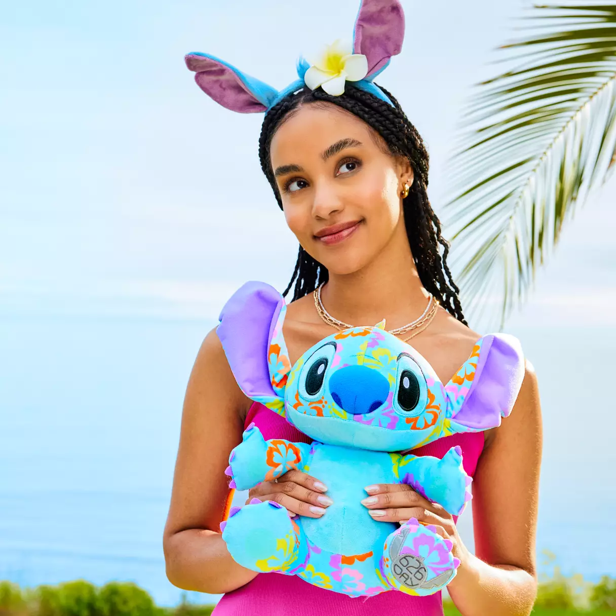 model holding stitch plush and wearing ears