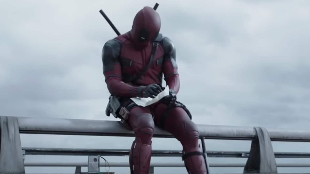 Deadpool sitting on a bridge