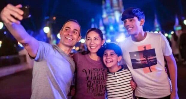 Family taking a selfie in front of Cinderella Castle