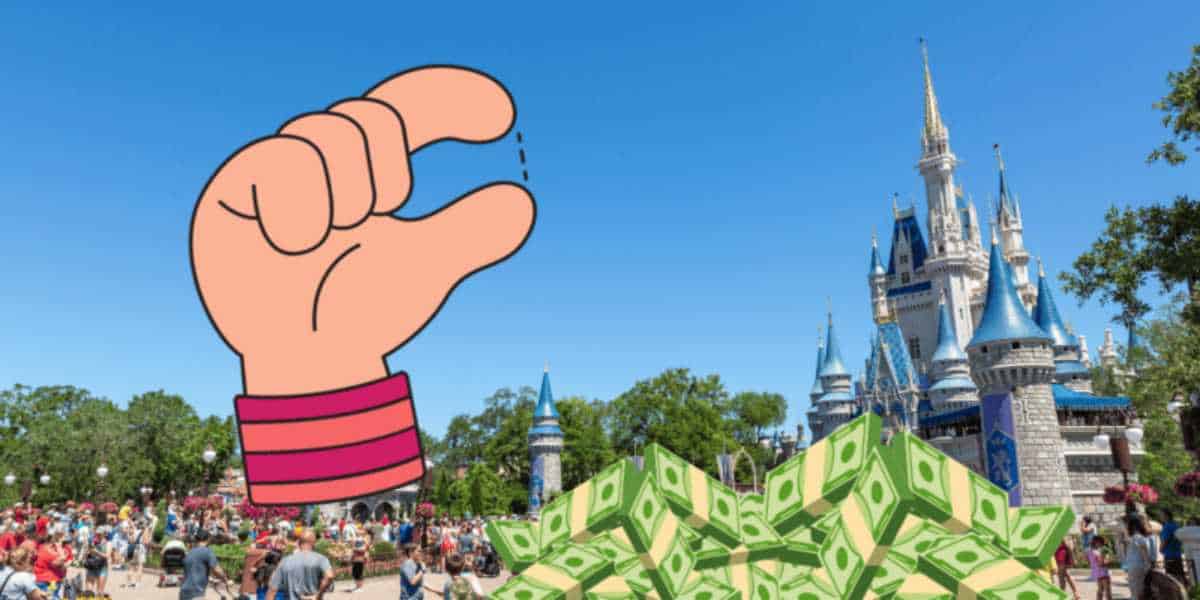 Hand and animated money with Disney park behind it