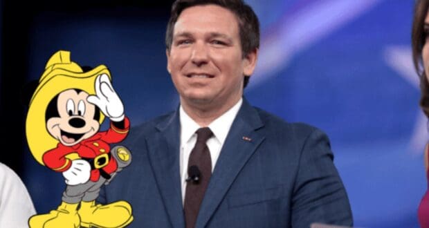 Mickey mouse on fire fighter outfit with DeSantis behind him