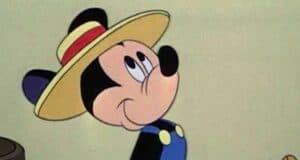 Mickey mouse with a blue shirt and a hat