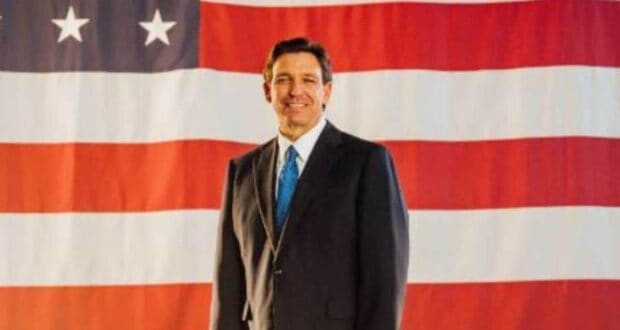 Ron Desantis with the flag of america behind him