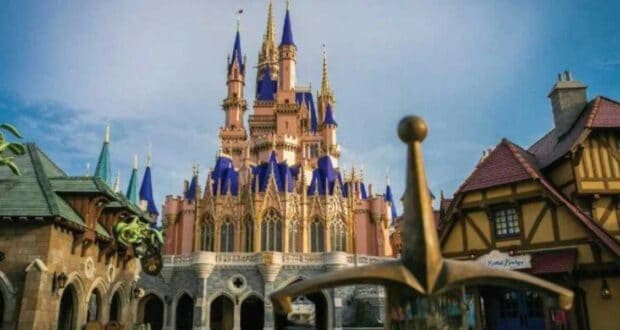 Cinderella Castle with its iconic blue spires rises behind the Sword in the Stone at Magic Kingdom, inviting families to experience the magic of Walt Disney World in Orlando—even as discussions swirl around a $100 billion budget.