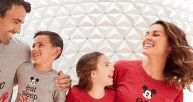 A smiling family of four, all in matching Mickey Mouse shirts, stand close together in front of a geometric patterned wall, laughing and looking at each other—perhaps unaware that many Floridians don't want more people to move there.