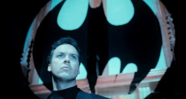 Michael Keaton as Bruce Wayne in front of the Bat signal