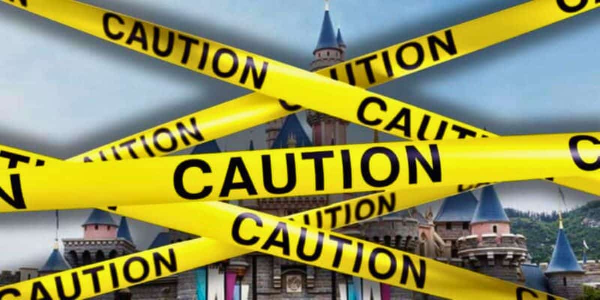 An image showing a castle behind multiple yellow "Caution" tapes crossing each other diagonally. The tapes obstruct a clear view of the castle, suggesting restricted access—much like a scene where Disney magic is temporarily off-limits.