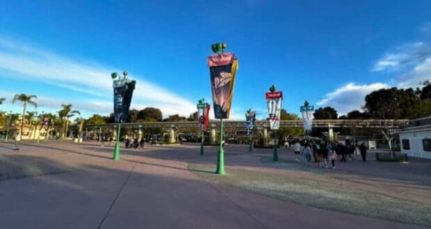 The Disneyland Resort esplanade that guests park hopping walk through, looking toward Disneyland Park, with banners of different Disney movies and attractions