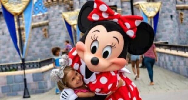 Minnie Mouse hugging a Disney Guest