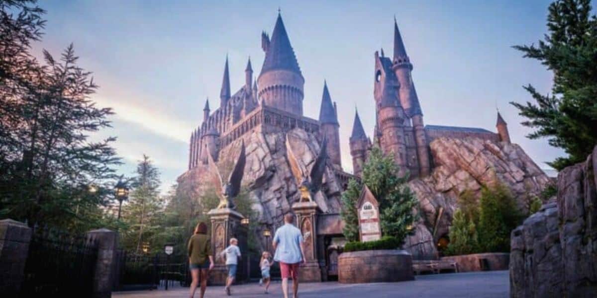 A family walks towards Hogwarts Castle in The Wizarding World at Universal
