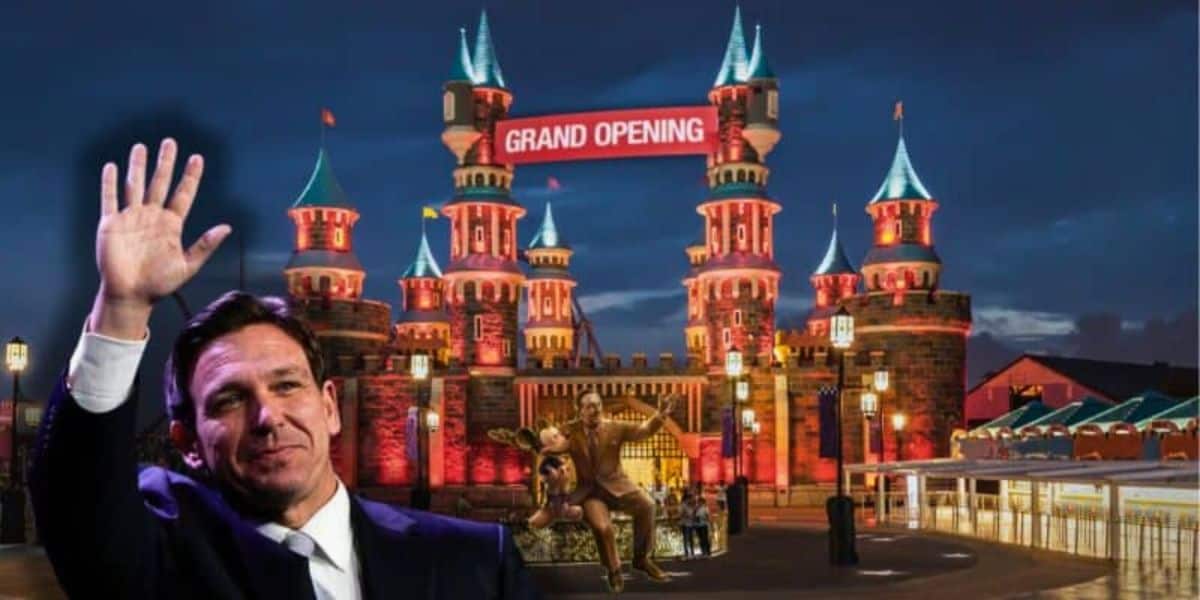 Ron DeSantis waves in front of an illuminated castle with a "Grand Opening" sign. The scene appears to be at night, with Ron DeSantis standing alongside a Walt Disney and Mickey Mouse in front of the castle.
