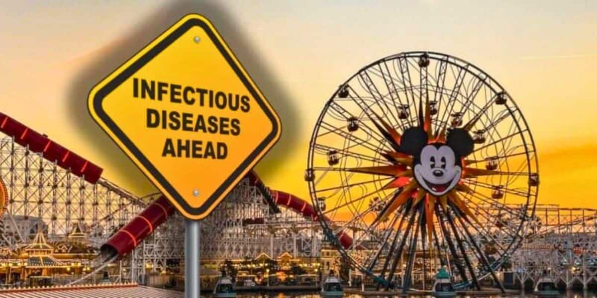 A large yellow caution sign reading "Infectious Diseases Ahead" is superimposed over an amusement park scene at sunset. The park, reminiscent of a Disney wonderland, features a Ferris wheel with a large Mickey Mouse face at its center and various roller coasters in the background.