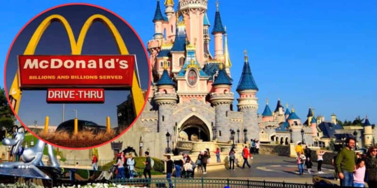 A vibrant scene at a Disney theme park features a fairytale castle with blue and pink towers. People are seen walking and enjoying the sunny day. Inset is a McDonald's drive-thru sign. The juxtaposition forces an element of modern commercialism into the magical setting, blending fantasy with reality.