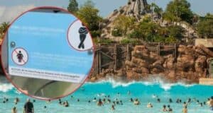 A busy wave pool at a water park with people swimming and playing in the water, one of the top attractions. A rocky mountain and lush greenery are in the background. In the foreground, there is an inset of a sign with safety instructions, though the text on the sign is not fully clear.