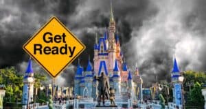 A dramatic image of a castle with dark storm clouds in the background. In the foreground, there's a yellow road sign that reads, "Get Ready." Statues of two characters holding hands stand in front of the castle, which has multiple spires with blue roofs.