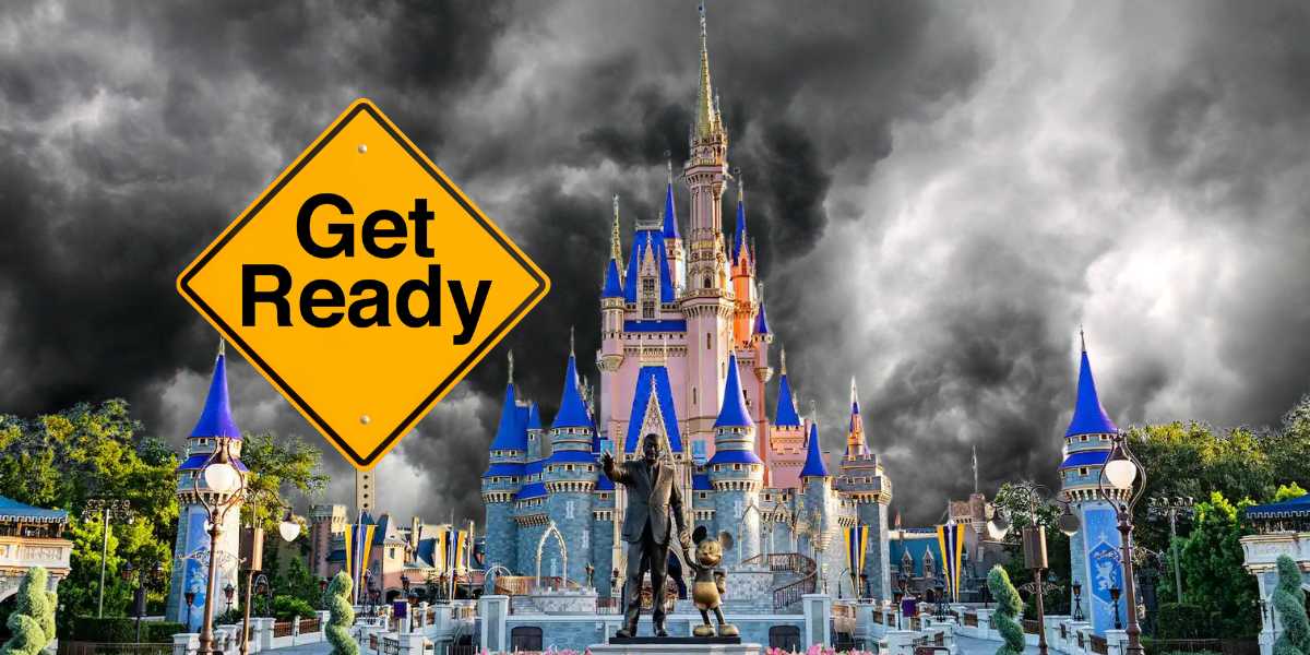 A dramatic image of a castle with dark storm clouds in the background. In the foreground, there's a yellow road sign that reads, "Get Ready." Statues of two characters holding hands stand in front of the castle, which has multiple spires with blue roofs.