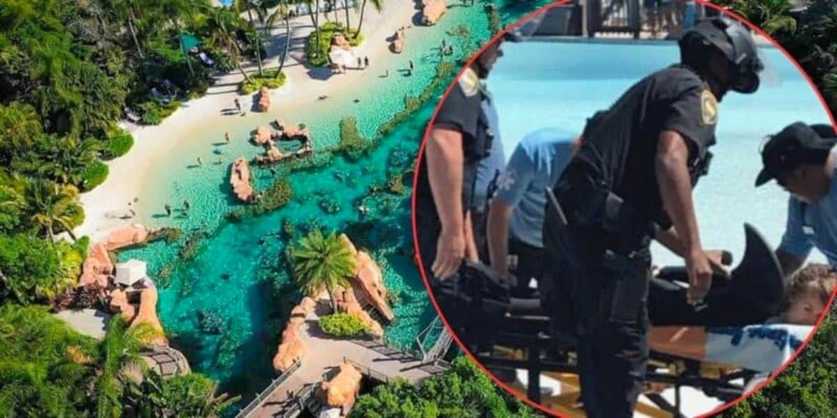 Aerial view of a tropical aquatic park with clear blue water, rocks, and lush greenery. Inset image shows first responders helping a person on a stretcher. The two contrasting scenes indicate an emergency occurred at the otherwise tranquil location.