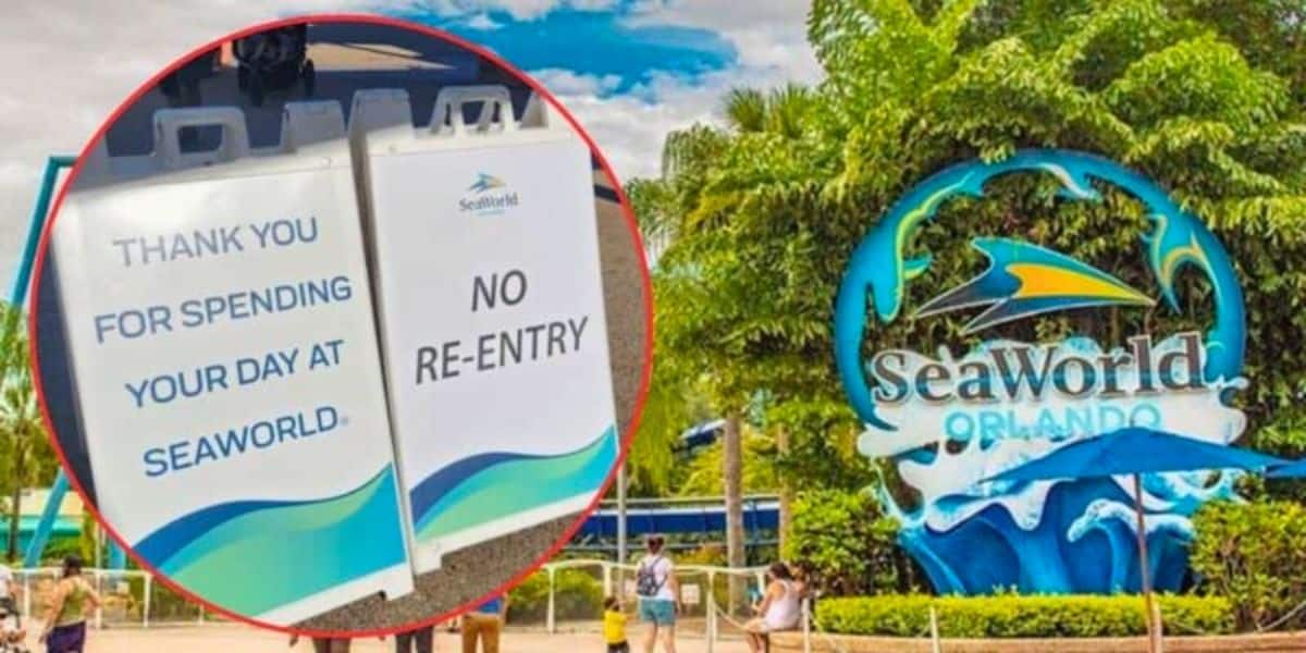 Two signs are displayed, one thanking visitors for spending their day at SeaWorld and the other signaling no re-entry. In the background, a large SeaWorld Orlando sign is surrounded by greenery and people are seen walking around.