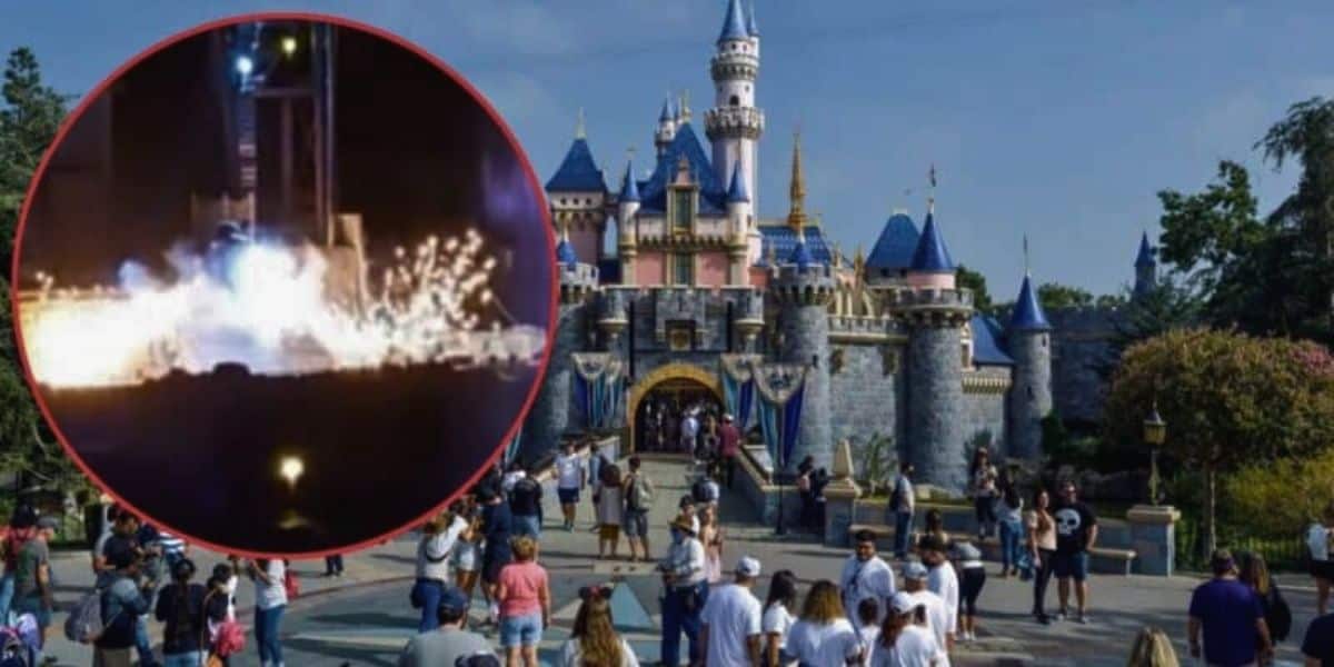 A bustling crowd stands in front of an iconic castle with blue-tiled roofs and towers at Disneyland during daytime. An inset image in the top left corner shows a nighttime scene of fireworks, smoke, and Mickey Mouse, suggesting an event or celebration.