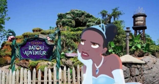 A cartoon princess in a blue dress and tiara stands with an unamused expression in front of a colorful sign that reads "Tiana's Bayou Adventure." The background features lush greenery, a water tower, and a whimsical wooden fence, evoking the charm of Disney World.
