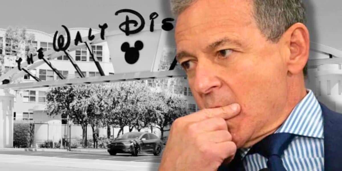 Disney CEO Bob Iger looking worried in front of the Walt Disney Company building.