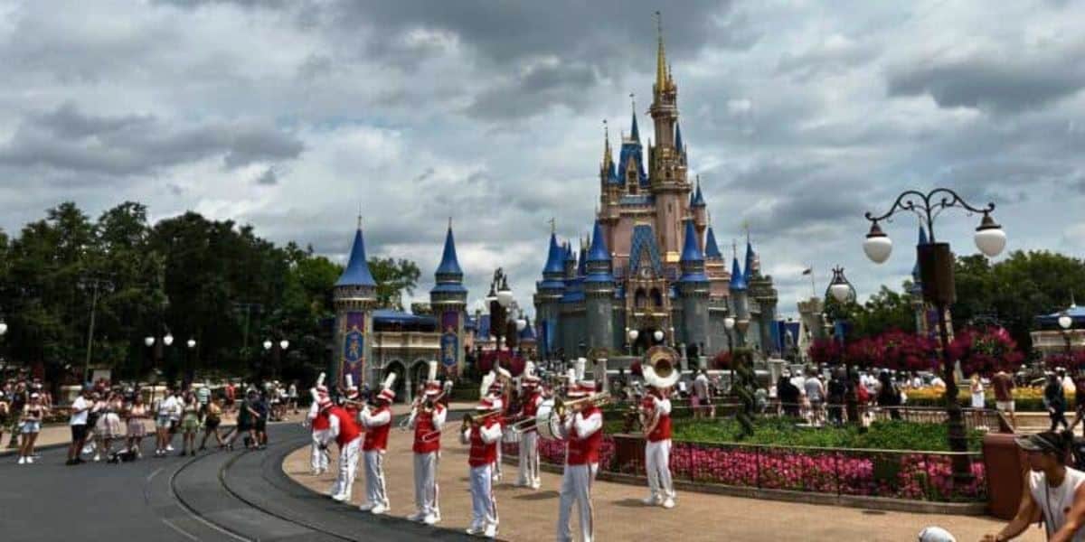 Guests enjoying a performance of the Main Street Philharmonic at Main Street, U.S.A., with Cinderella Castle in the background at Magic Kingdom