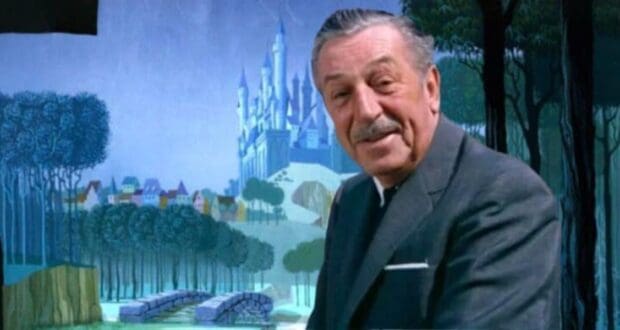 An older man in a suit stands smiling in front of a mural reminiscent of Disney World, depicting a fairytale landscape with a castle, trees, and an enchanting bridge. The background is colorful and illustrated in a whimsical style.