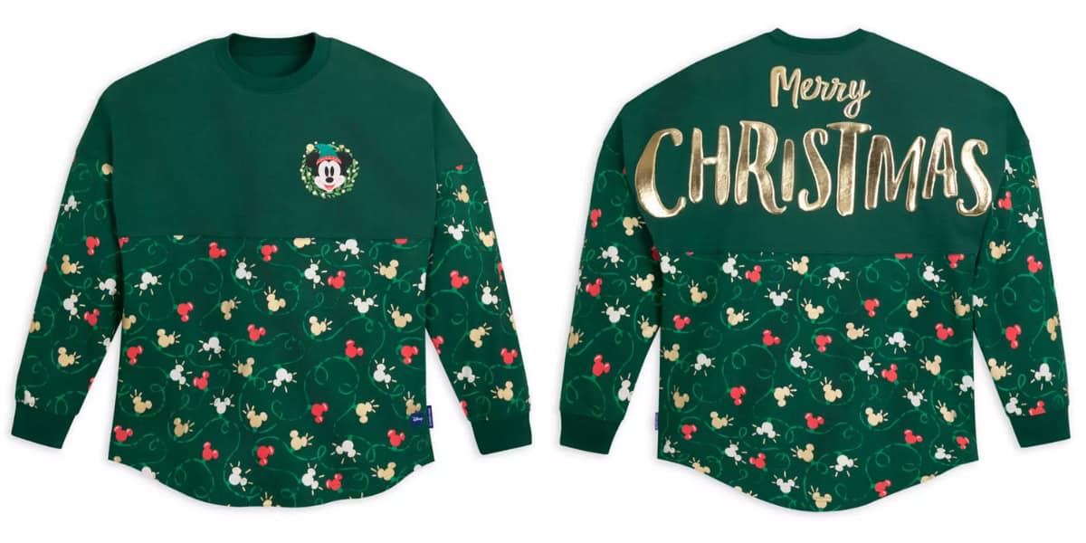 Front and back view of a green long-sleeve Christmas sweater adorned with festive patterns, including holly and Mickey Mouse silhouettes. The front features a small Mickey Mouse wreath, and the back has "Merry Christmas" written in large, gold, festive letters.