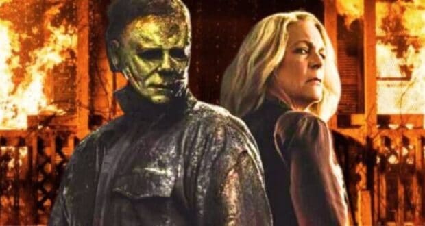 Michael Myers (James Jude Courtney) and Laurie Strode (Jamie Lee Curtis) in 'Halloween Ends' with the burning house from 'Halloween Kills' behind them