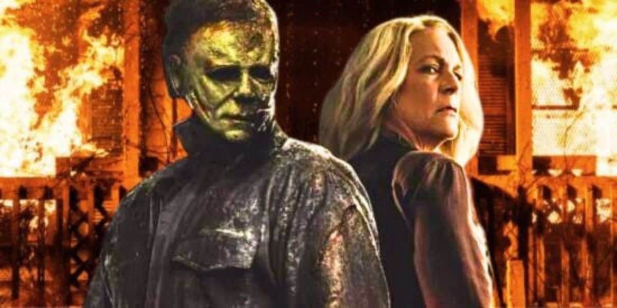 Michael Myers (James Jude Courtney) and Laurie Strode (Jamie Lee Curtis) in 'Halloween Ends' with the burning house from 'Halloween Kills' behind them