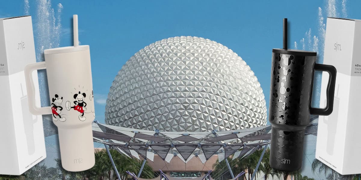 Two Simple Modern Disney travel mugs are featured prominently in front of the Epcot geodesic sphere. The white mug with a Mickey and Minnie design is on the left, and the black embossed mug is on the right. Both mugs have straws and are shown with their packaging.