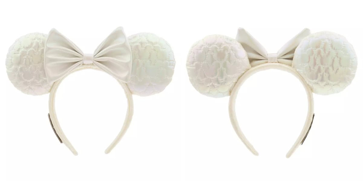 A pair of headbands featuring large, round, textured white ears and an off-white bow in the center. The ears have a quilted appearance, and the headband is sleek and simple.