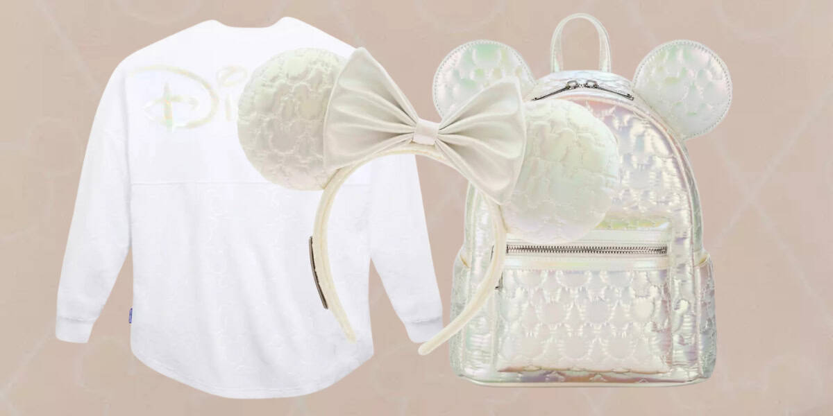 A white long-sleeve shirt, a pair of white Mickey Mouse ears with a large bow, and a shiny holographic backpack with Mickey Mouse ear details are arranged against a light beige background.