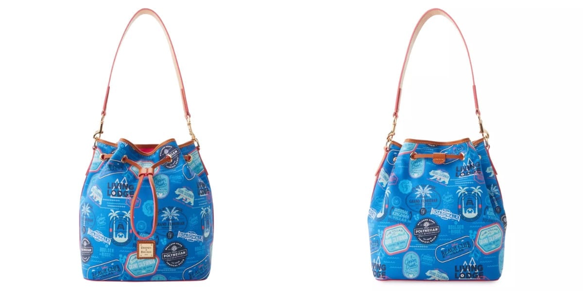 Two images of a blue bucket handbag with a colorful travel-themed print featuring various labels and stickers. The bag has tan leather straps, a drawstring closure, and gold hardware. Both images show the bag from slightly different angles.