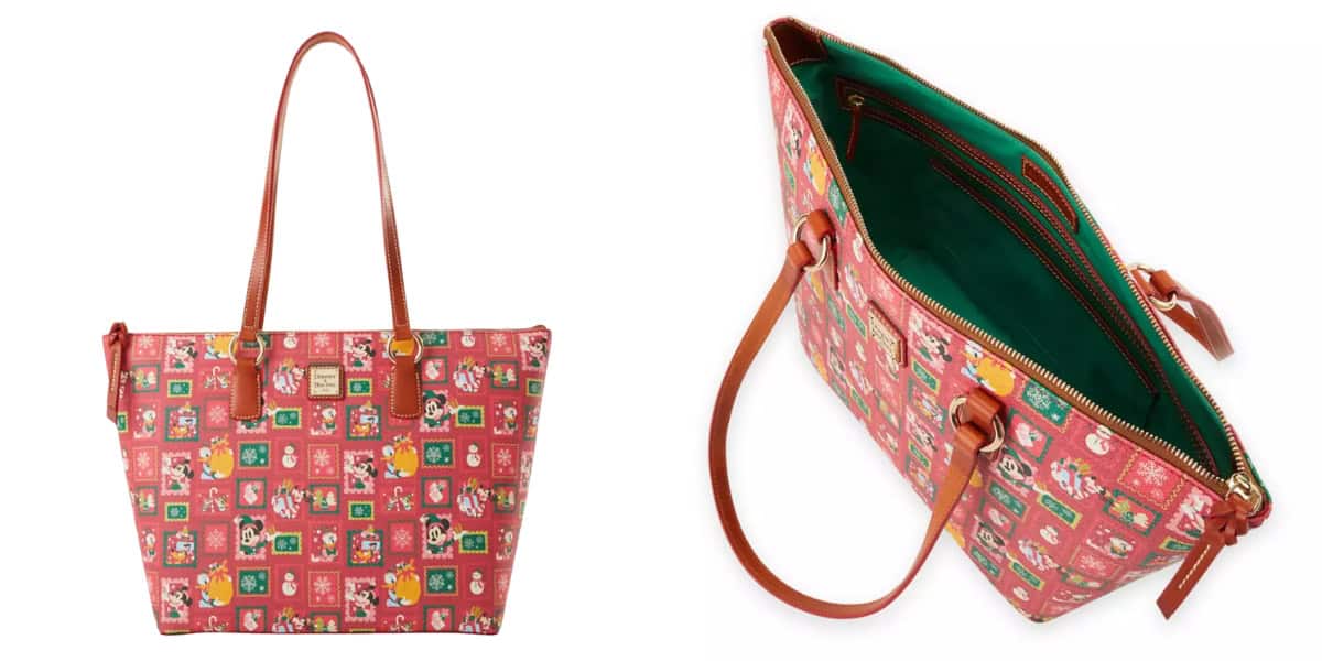 A red tote bag with brown straps featuring Disney characters in holiday attire and various festive motifs. The interior is green with multiple pockets and a zipper closure.