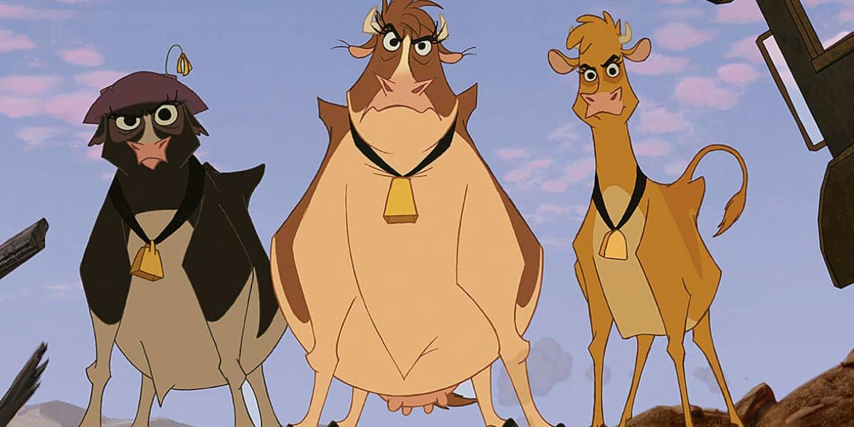 Three animated cows stand together, each with a bell around their neck. The cows vary in color and expression, with a sky and partial view of a wagon in the background.
