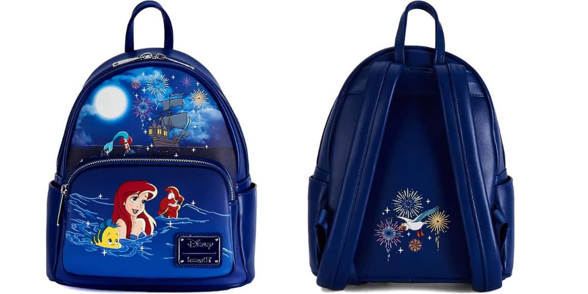 Front and back view of a blue backpack featuring a Little Mermaid design. The front shows Ariel, Flounder, and a ship under a moonlit sky, while the back has fireworks.