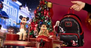 A festive scene with Mickey and Minnie Mouse in holiday outfits standing in front of a decorated Christmas tree. A hand holds a black Disney backpack with Mickey and Minnie designs, surrounded by hanging string lights.