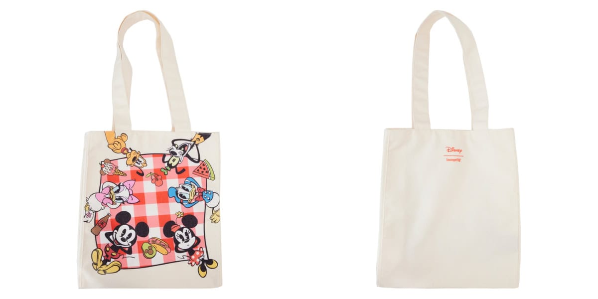 A cream-colored tote bag is shown in two views: front and back. The front has Disney characters Mickey, Minnie, Donald, Daisy, Goofy, and Pluto enjoying a picnic on a red and white checkered blanket. The back has a small red "Disney Loungefly" logo.