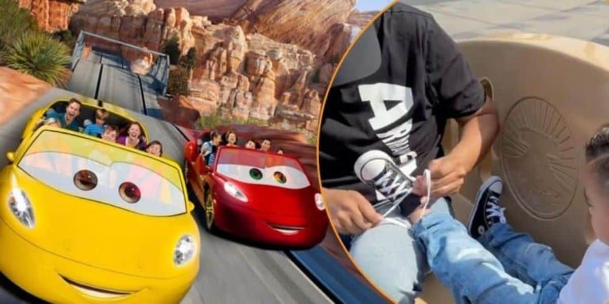 A family rides in colorful cars on a roller coaster, set against a backdrop of rocky mountains. A child on the ride is wearing sneakers, and an adult is tying their shoelace.