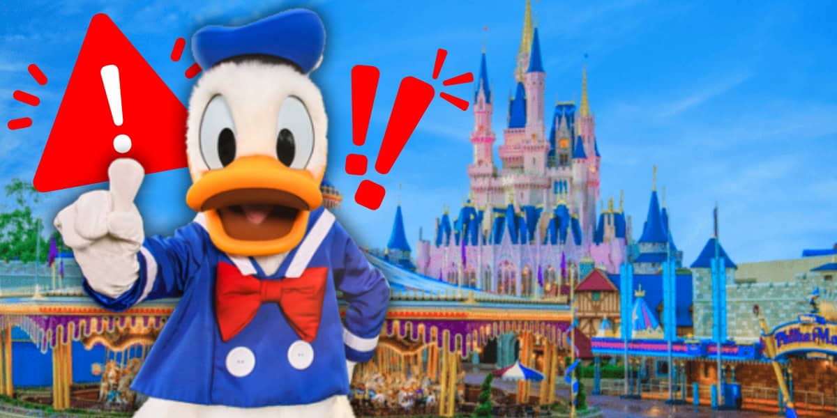 Donald Duck, wearing a blue sailor outfit and red bow tie, gestures with one hand raised in front of a colorful castle. Red exclamation marks and a warning triangle are overlaid on the image.