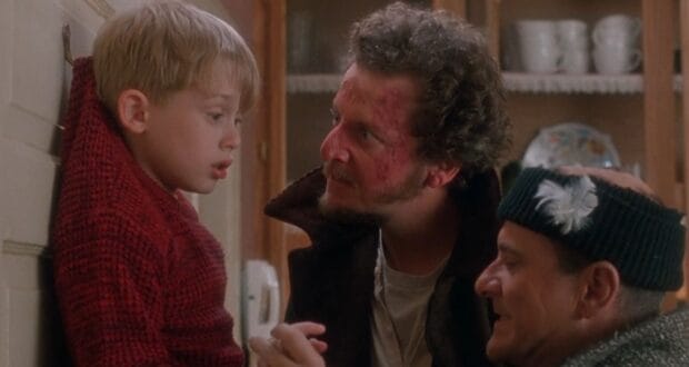 Kevin McCallister (Macaulay Culkin) is hooked on the wall by Harry and Marv (Joe Pesci and Daniel Stern) in 'Home Alone'